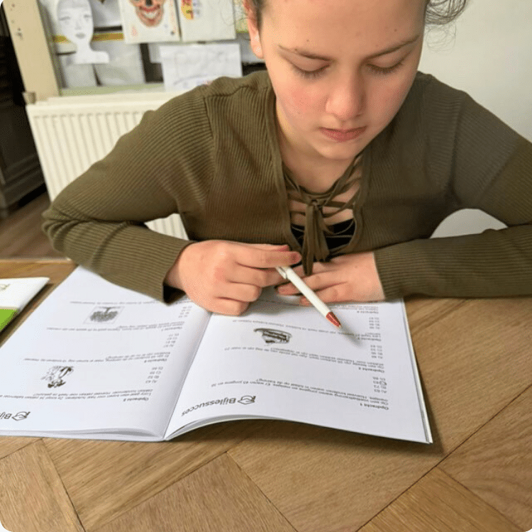 Leerling uit groep 8 werkt zelfstandig in een oefenboek met opdrachten voor rekenen lezen en spelling