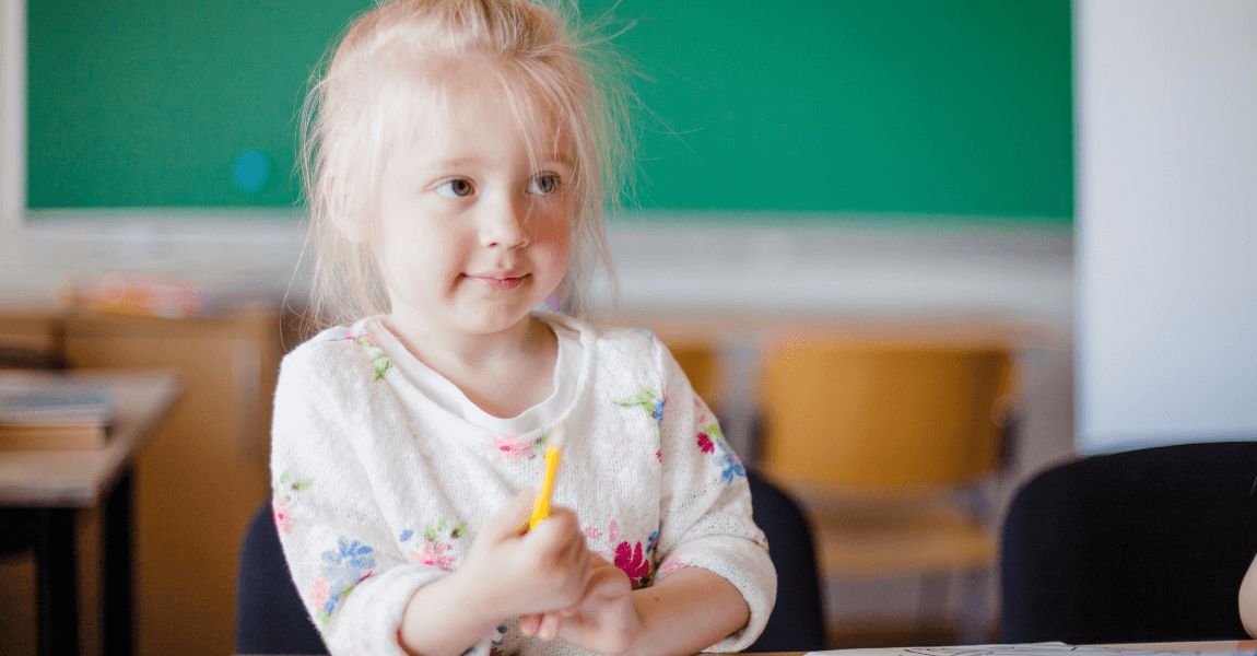 Jong kind oefent de dagen van de week in een klaslokaal op de basisschool